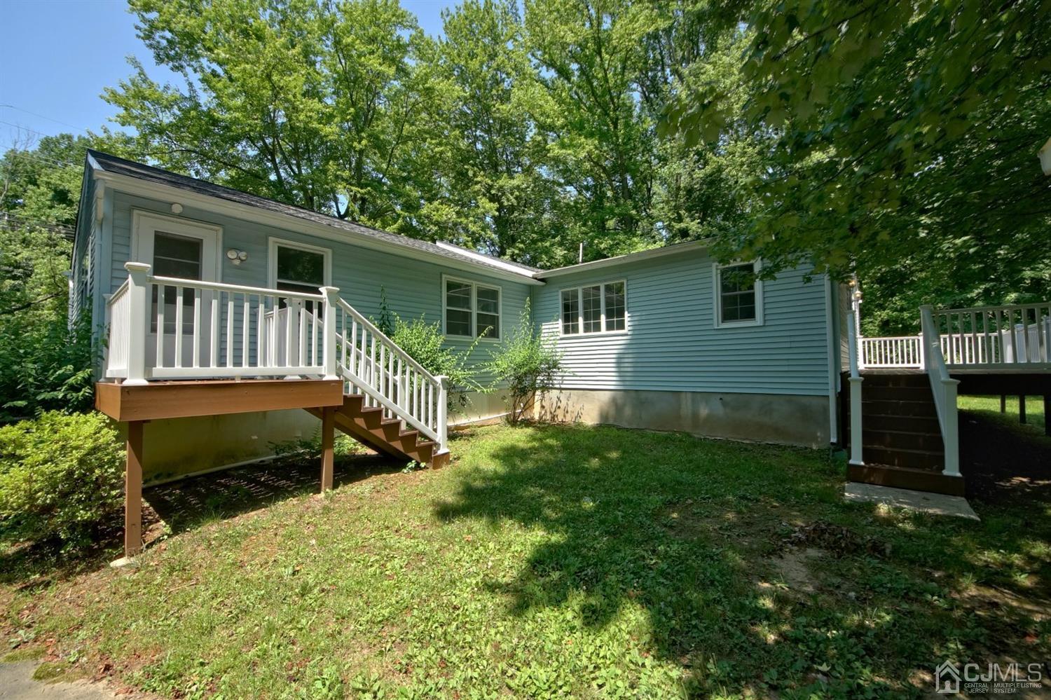 238 New Road Monmouth Junction, NJ 08852 - Photo 52 of 63 a front view of house with yard and green space