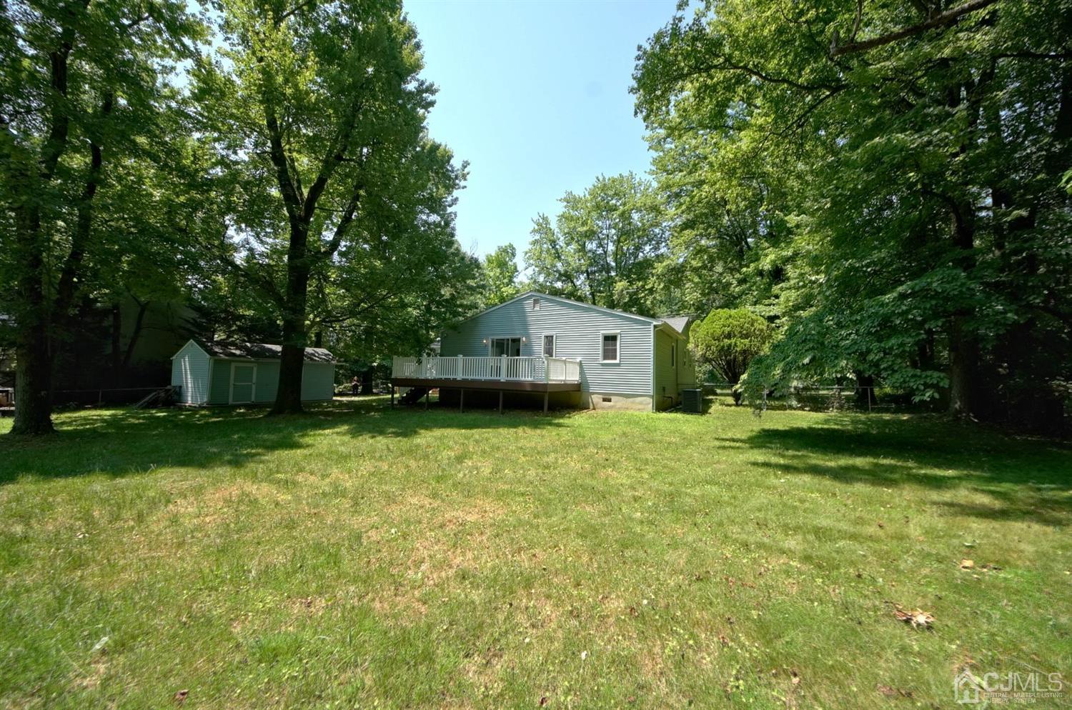 238 New Road Monmouth Junction, NJ 08852 - Photo 54 of 63 a front view of a house with a garden and trees