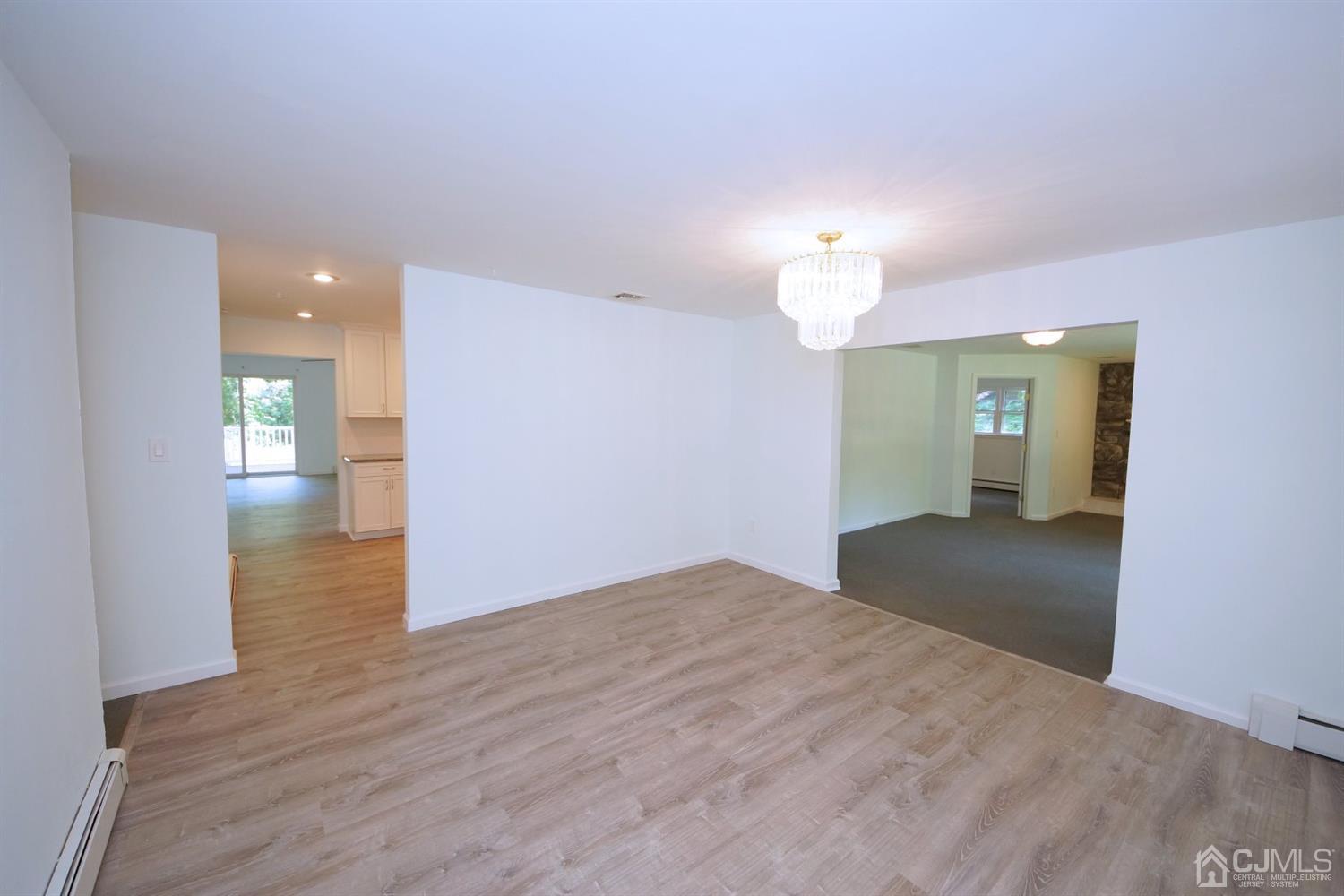 238 New Road Monmouth Junction, NJ 08852 - Photo 10 of 63 a view of empty room with wooden floor and window