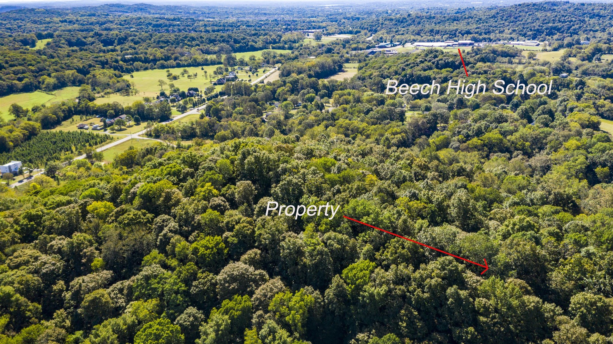 an aerial view of a houses with a yard