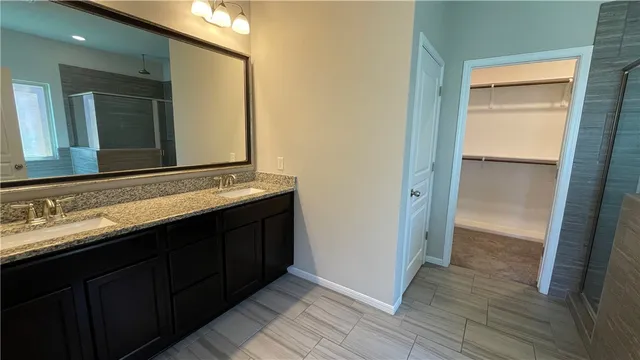 a bathroom with a double vanity sink and a mirror