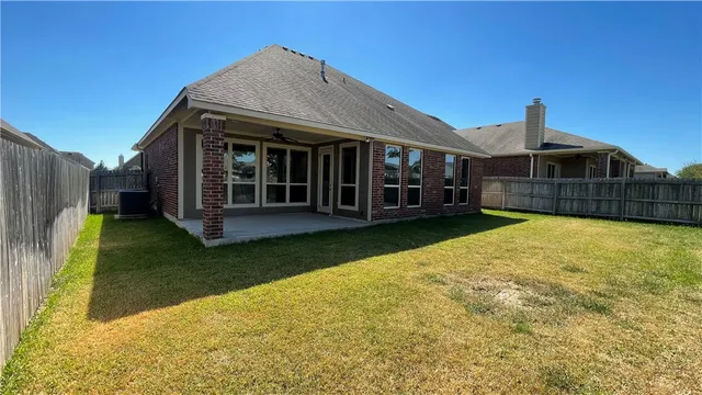 a view of a house with a yard and sitting area