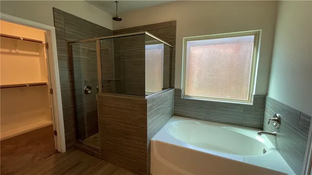 a bathroom with a bathtub and a shower
