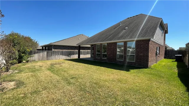 a view of a house with a yard and garage