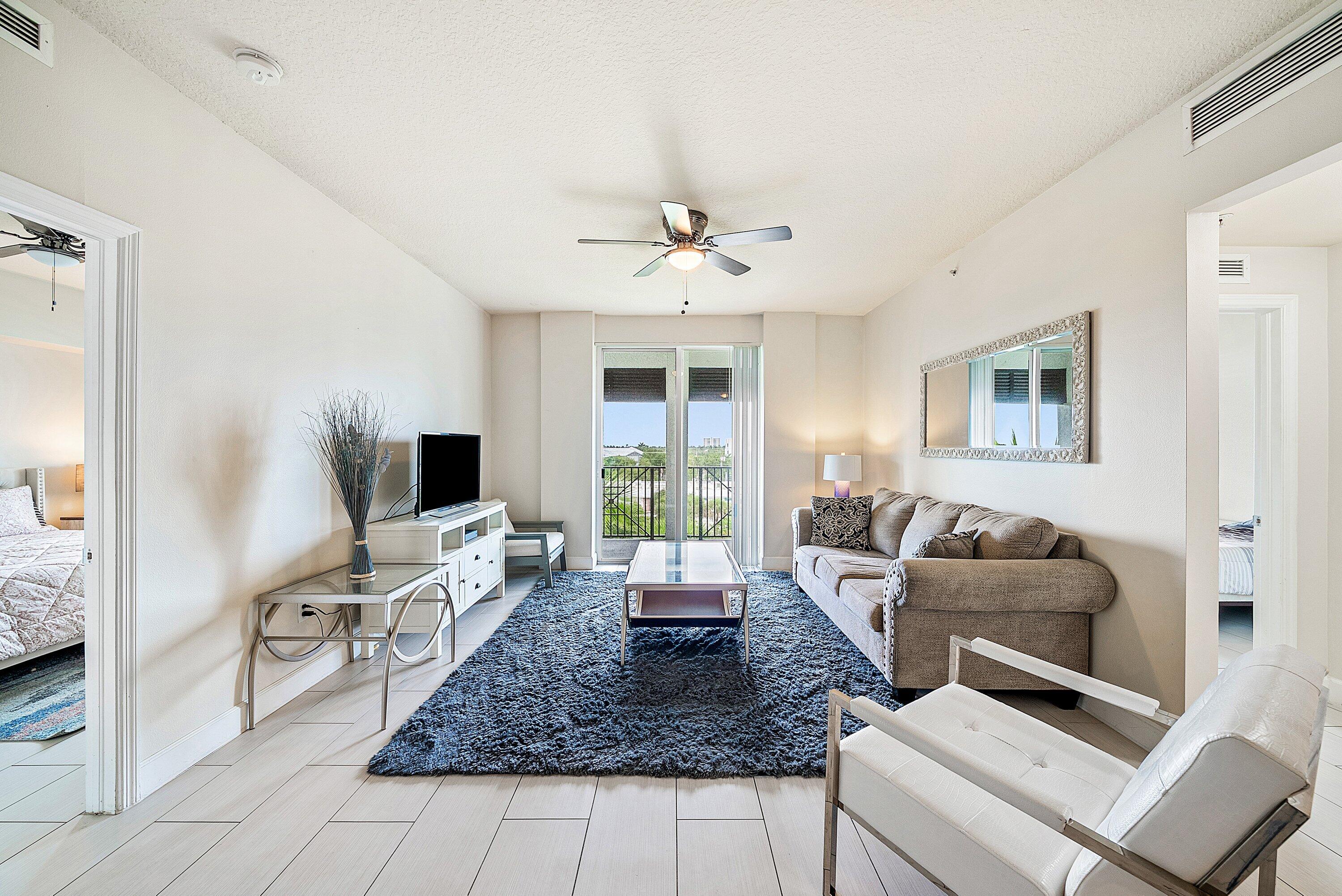 255 Northeast 3rd Avenue, Unit 2503 Delray Beach, FL 33444 - Photo 1 of 27 a living room with furniture and a flat screen tv
