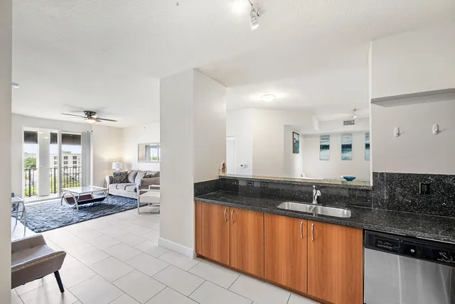 a large white kitchen with a sink and cabinets