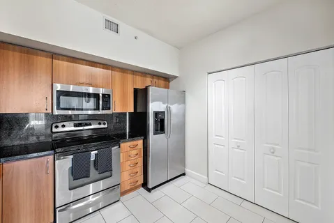 a kitchen with stainless steel appliances a refrigerator stove and microwave