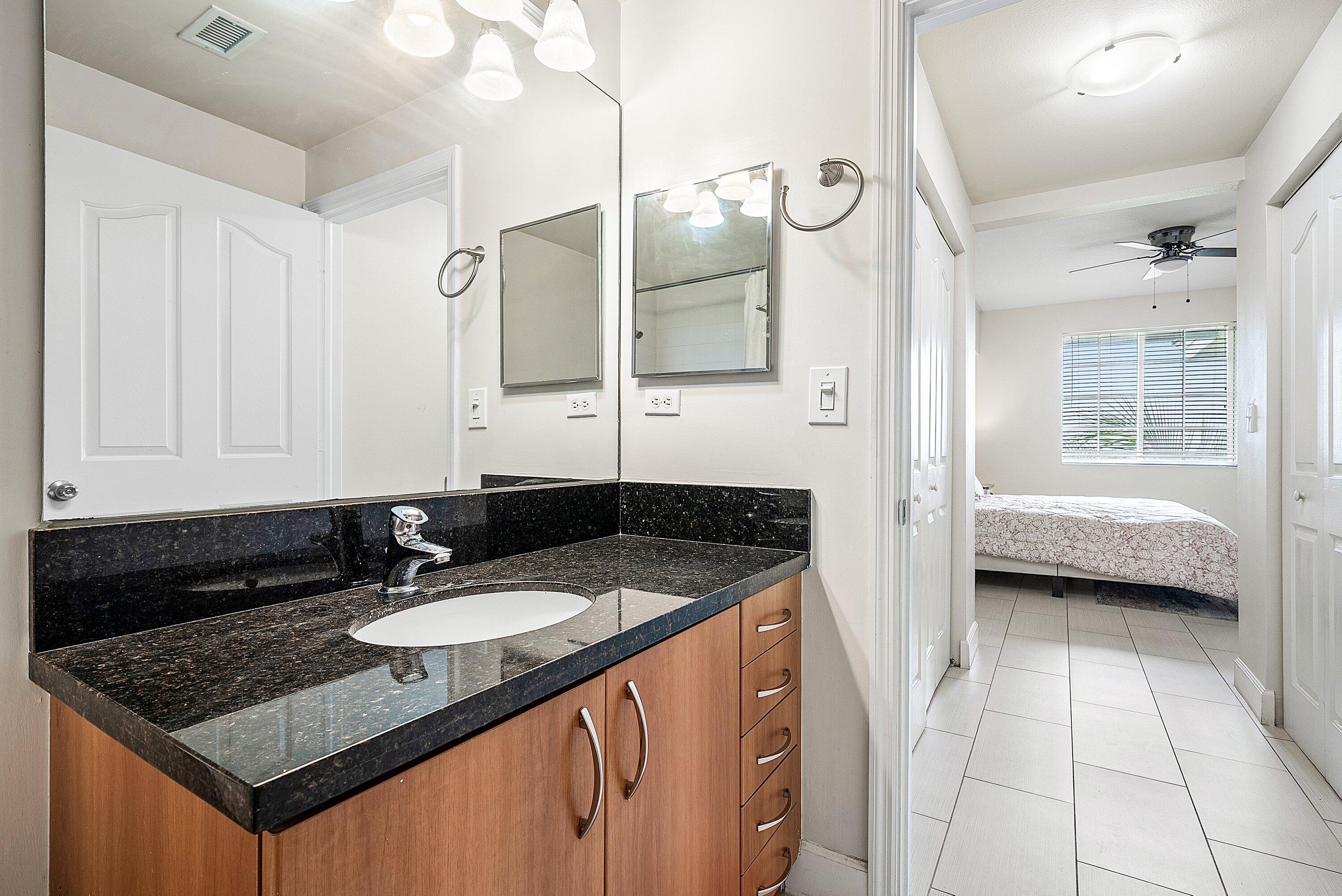255 Northeast 3rd Avenue, Unit 2503 Delray Beach, FL 33444 - Photo 17 of 27 a bathroom with a sink double vanity and a mirror