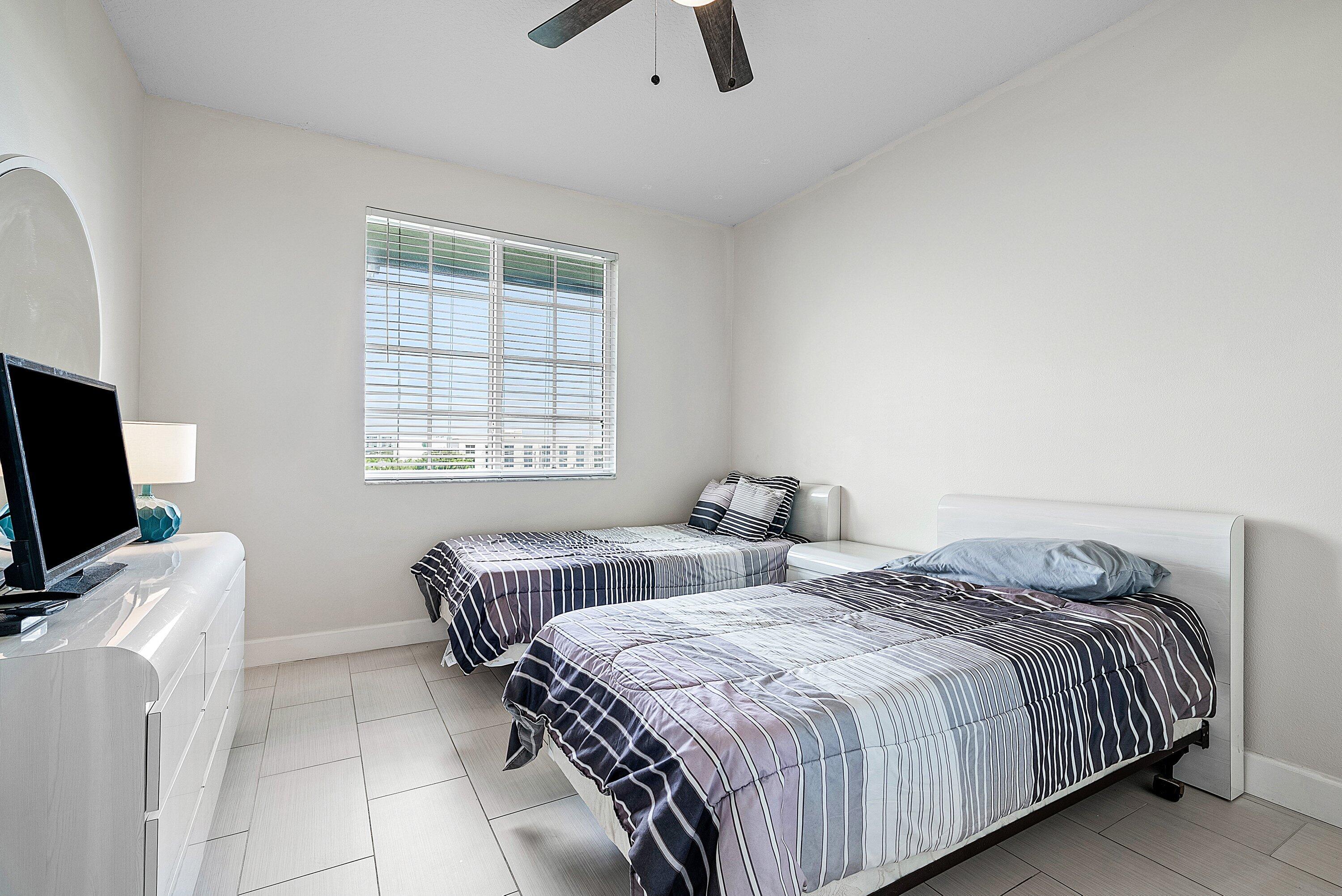 255 Northeast 3rd Avenue, Unit 2503 Delray Beach, FL 33444 - Photo 18 of 27 a bedroom with double bed and a flat screen tv