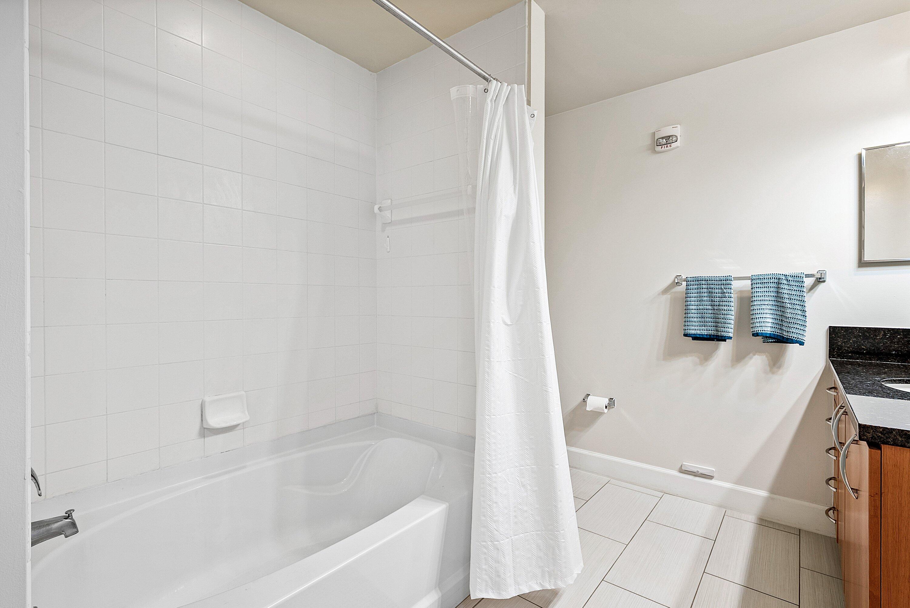 255 Northeast 3rd Avenue, Unit 2503 Delray Beach, FL 33444 - Photo 19 of 27 a bathroom with a bathtub and a shower