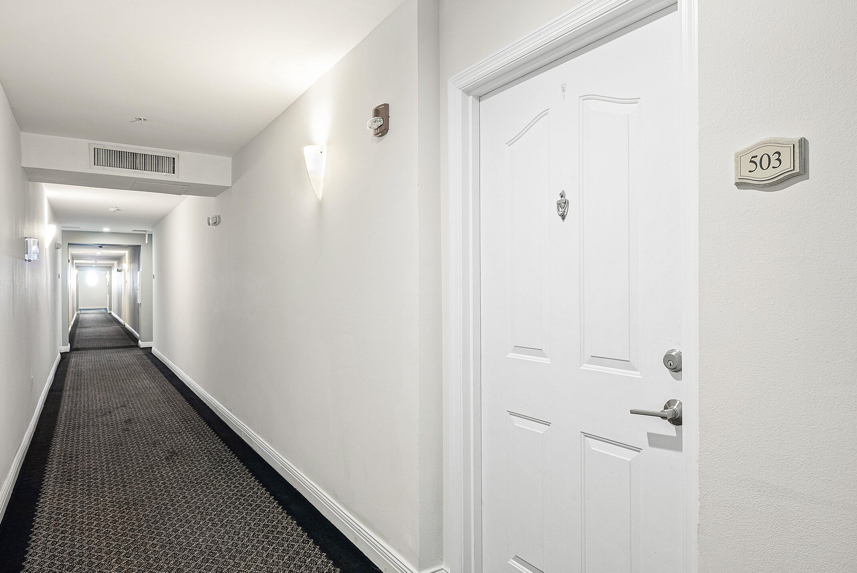 255 Northeast 3rd Avenue, Unit 2503 Delray Beach, FL 33444 - Photo 4 of 27 a view of a hallway with wooden floor