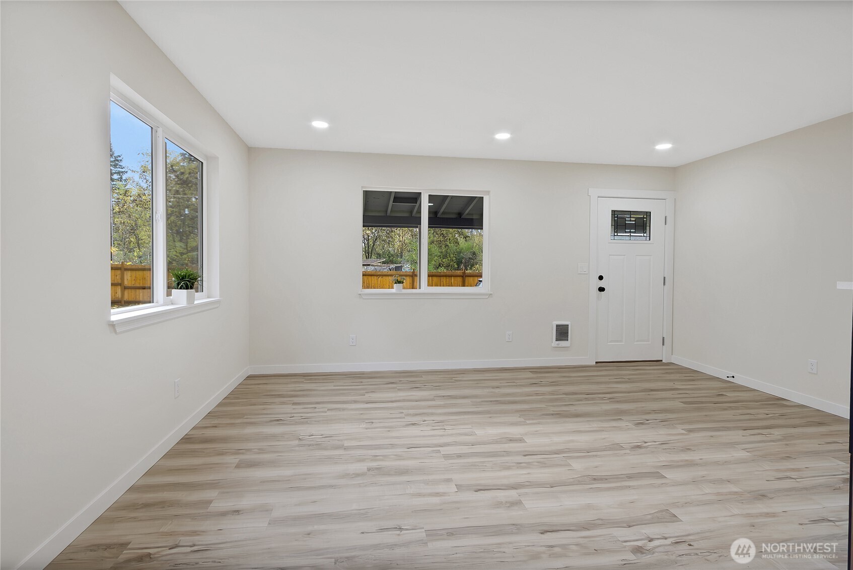 99 Sumner Avenue Sumner, WA 98390 - Photo 15 of 27 a view of an empty room with wooden floor and a window