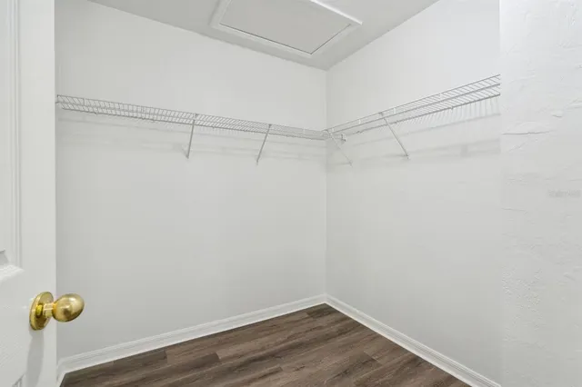 a view of walk in closet with clothes