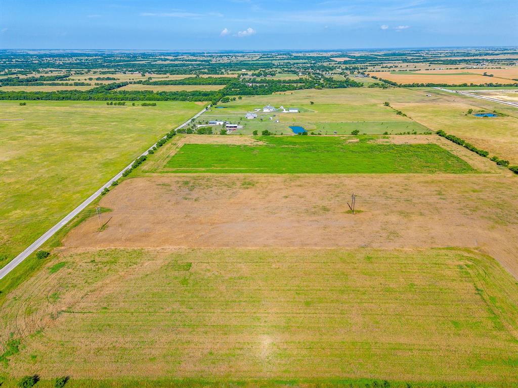 6785 Hoehn Road Valley View, TX 76272 - Photo 12 of 14 Expansive rural landscape featuring a paved road, multiple agricultural fields, and natural tree lines