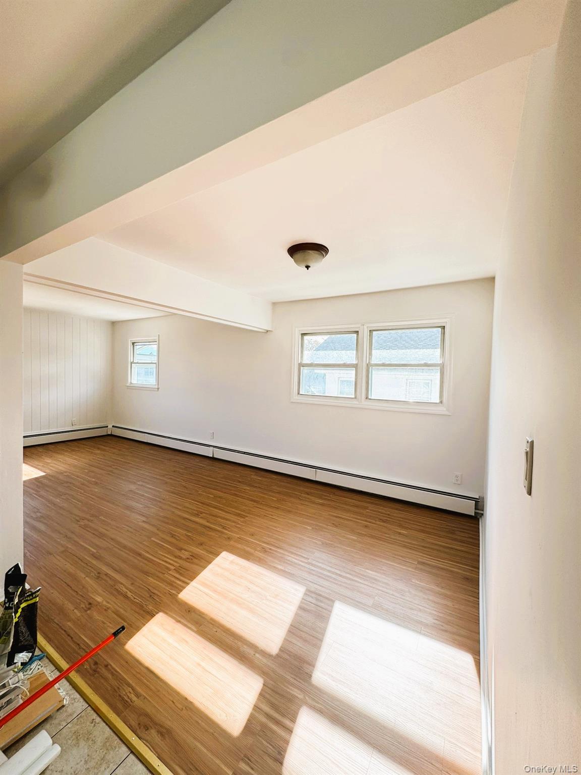 131 Roslyn Road, Unit 1 Mineola, NY 11501 - Photo 1 of 17 a view of a room with wooden floor and white walls