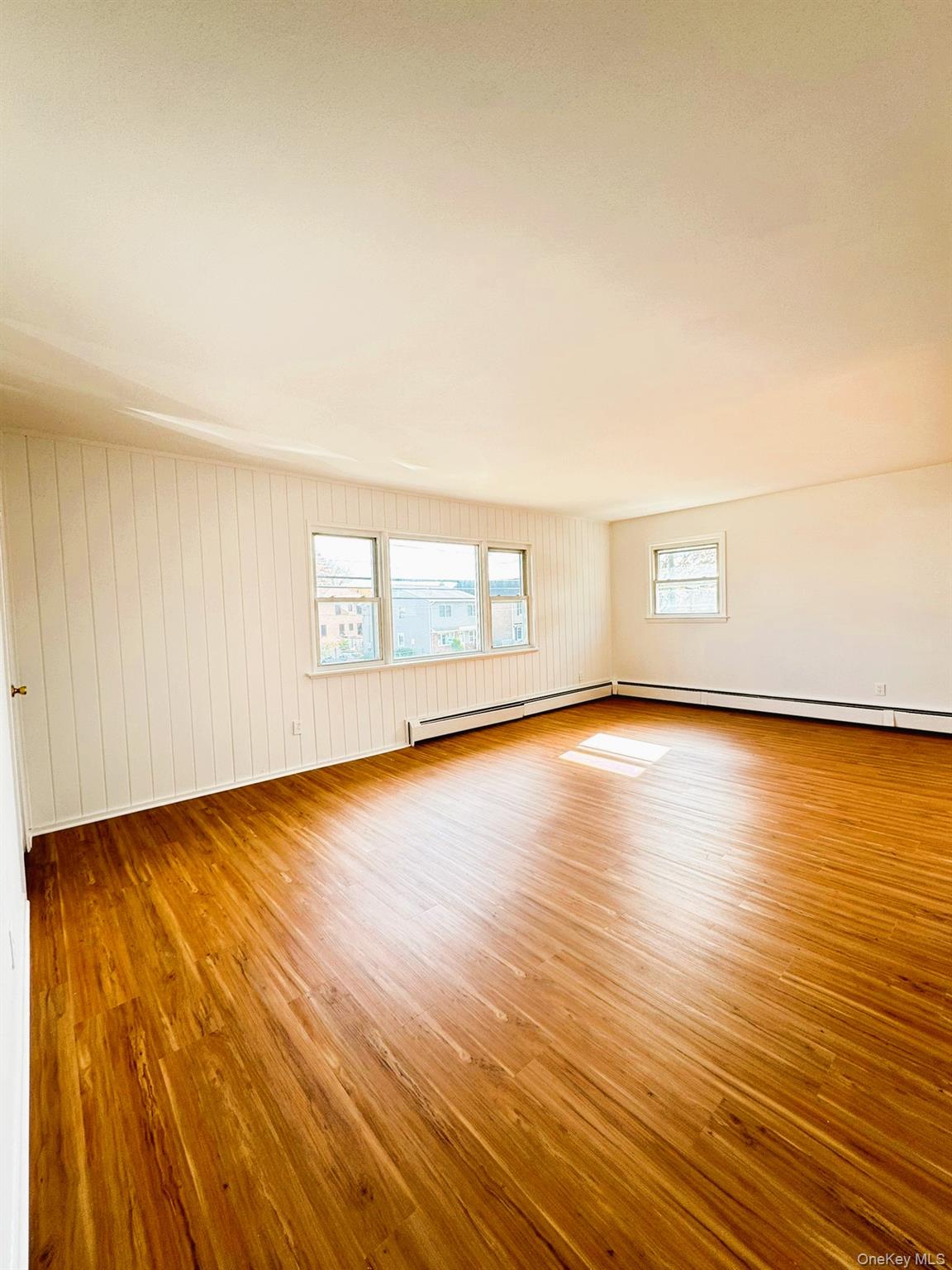 131 Roslyn Road, Unit 1 Mineola, NY 11501 - Photo 8 of 17 a view of empty room with wooden floor and fan