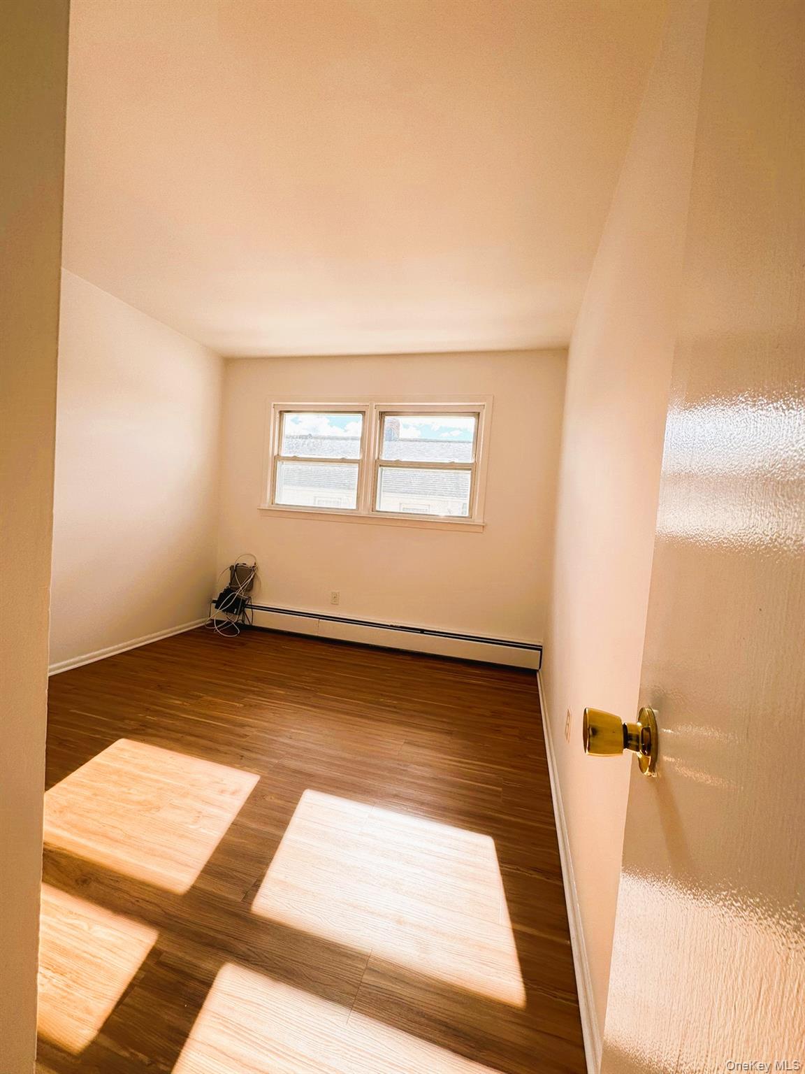 131 Roslyn Road, Unit 1 Mineola, NY 11501 - Photo 10 of 17 a view of an empty room and window