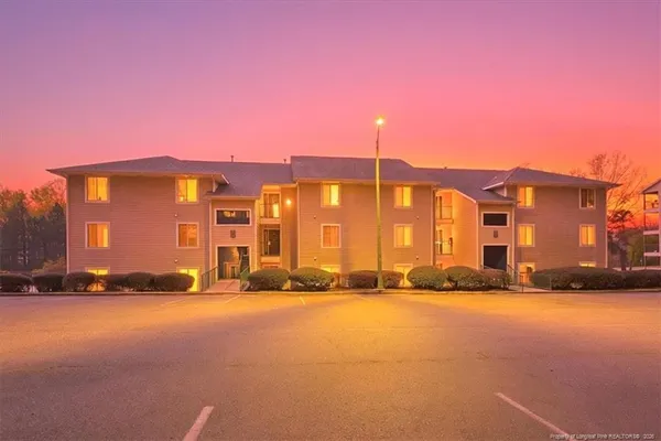 a front view of a building with a yard