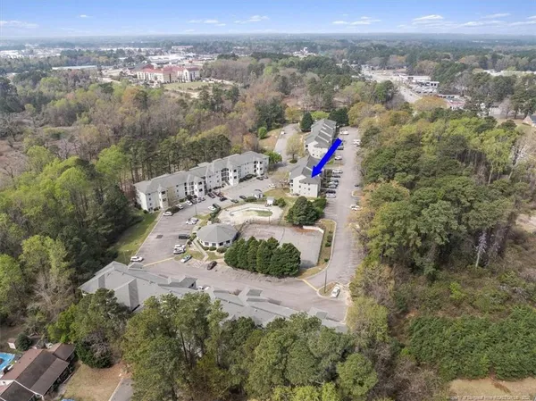 an aerial view of a house with outdoor seating