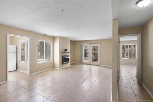 a view of an empty room with a fireplace