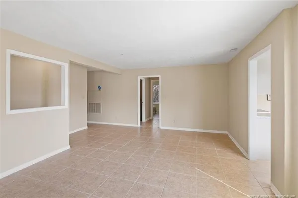 a view of an empty room with a fireplace