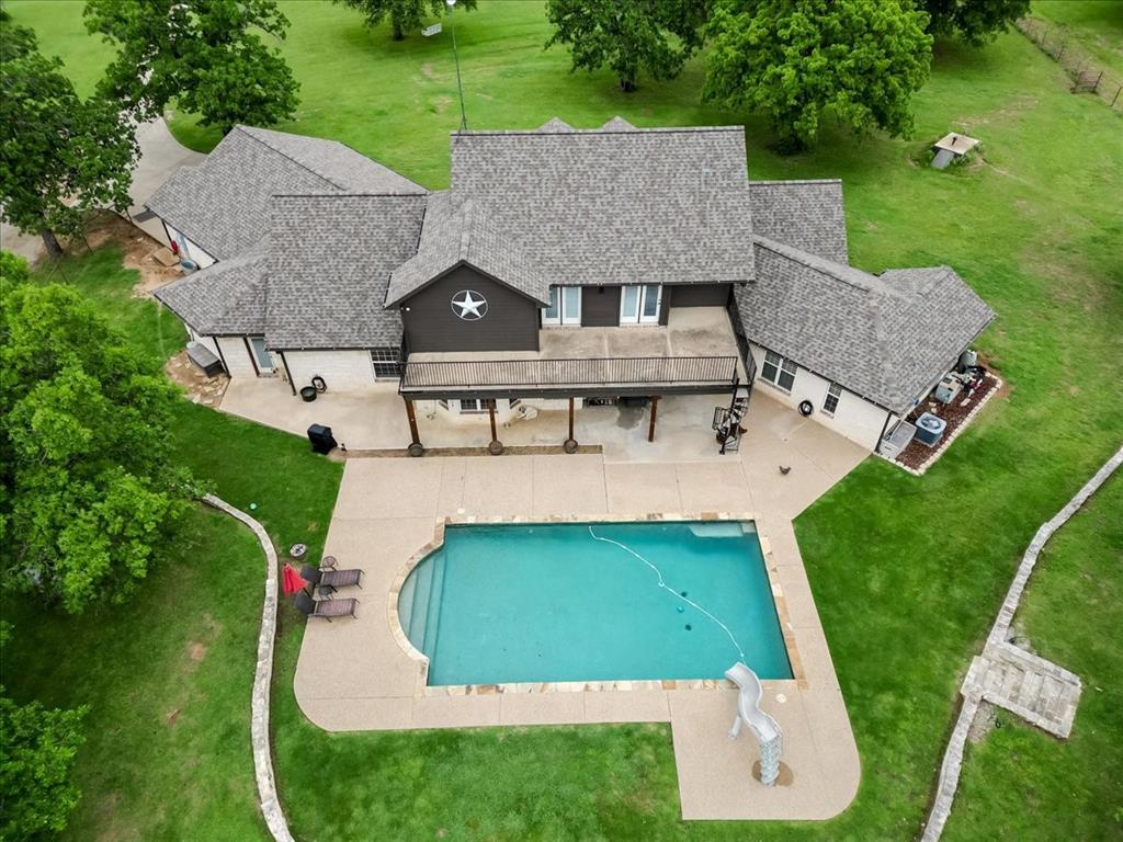 318 East Lone Star Road Poolville, TX 76487 - Photo 3 of 33 an aerial view of a house with swimming pool garden and patio