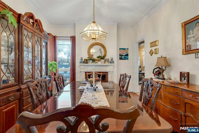 a kitchen with stainless steel appliances kitchen island granite countertop a table and chairs in it