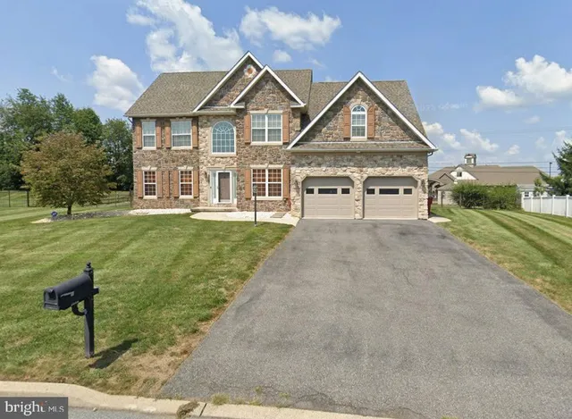 a view of a big house with a big yard and potted plants