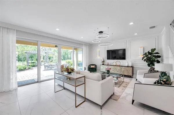 a living room with furniture and a large window