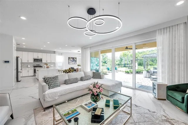a kitchen with white cabinets and chairs