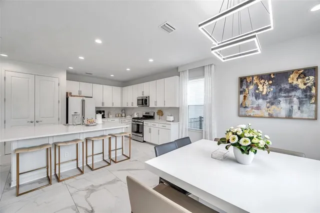 a bedroom with a large bed and a chandelier