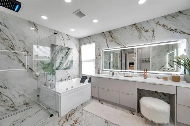 a bathroom with a granite countertop sink a toilet and shower