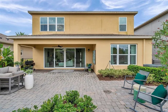 a view of a house with swimming pool and porch with furniture