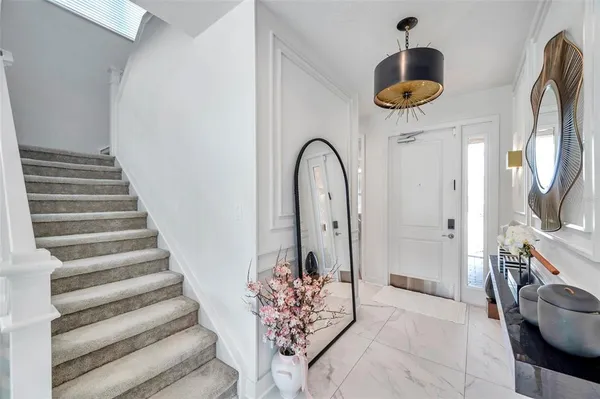 a view of entryway and hall with wooden floor