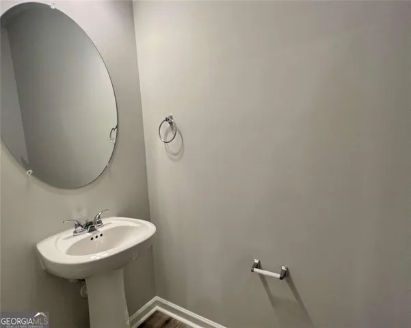 a bathroom with a sink a mirror and vanity