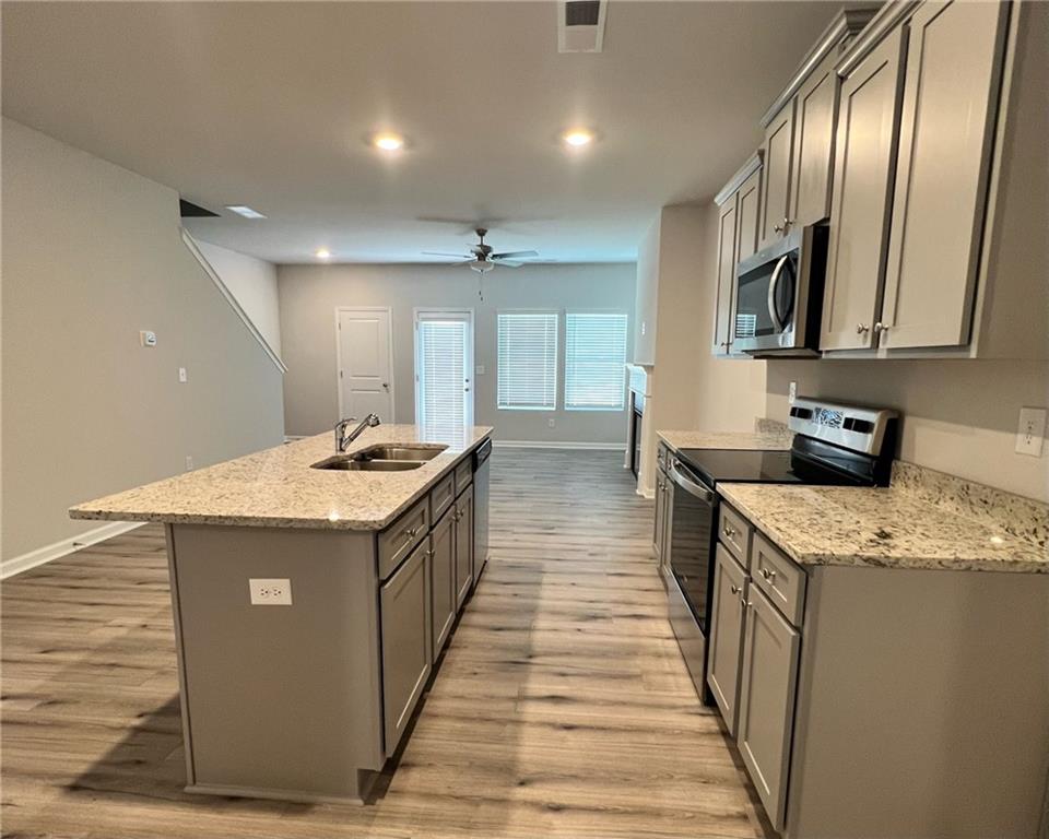 4352 Shaffer Ct Union, Unit 58 Union City, GA 30291 - Photo 6 of 19 a kitchen with stainless steel appliances granite countertop wooden cabinets a sink and a stove