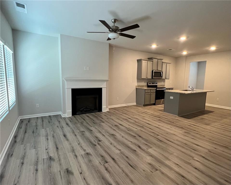 4352 Shaffer Ct Union, Unit 58 Union City, GA 30291 - Photo 8 of 19 a view of kitchen livingroom with wooden floor and a fireplace