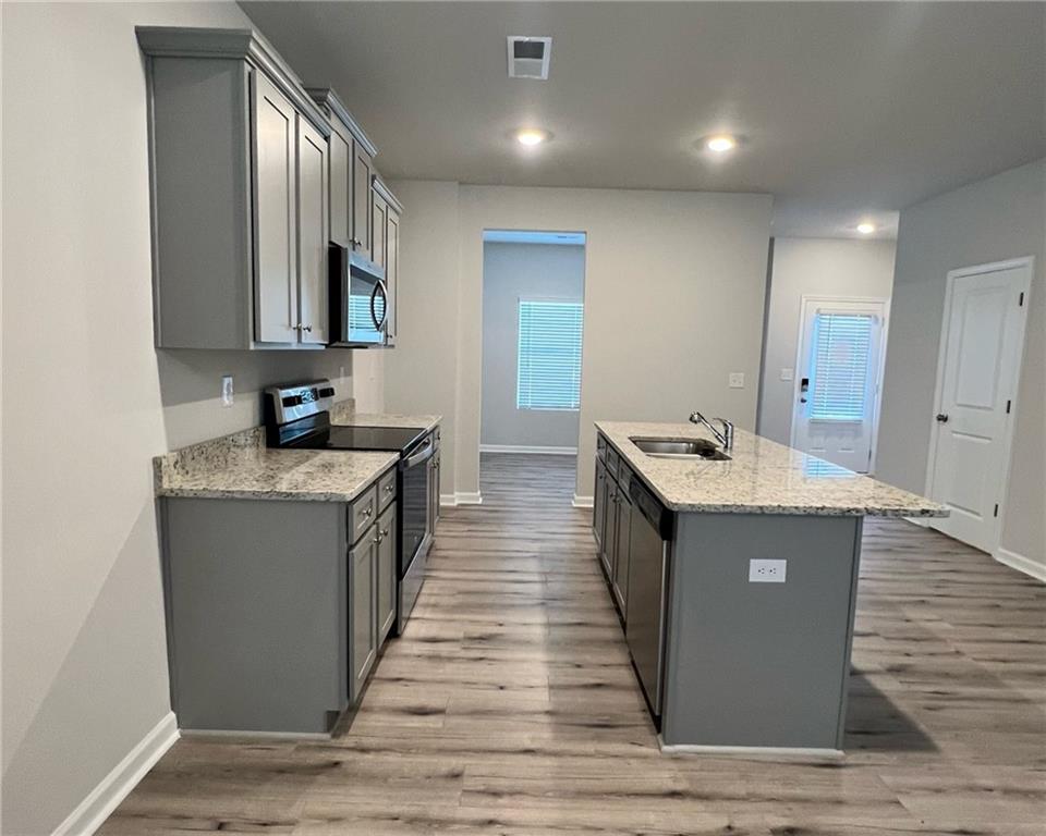 4352 Shaffer Ct Union, Unit 58 Union City, GA 30291 - Photo 9 of 19 a kitchen with sink and wooden cabinets