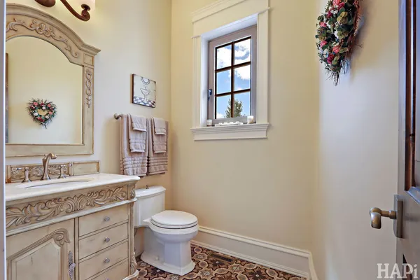 a kitchen with white cabinets a sink dishwasher and a stove with wooden floor