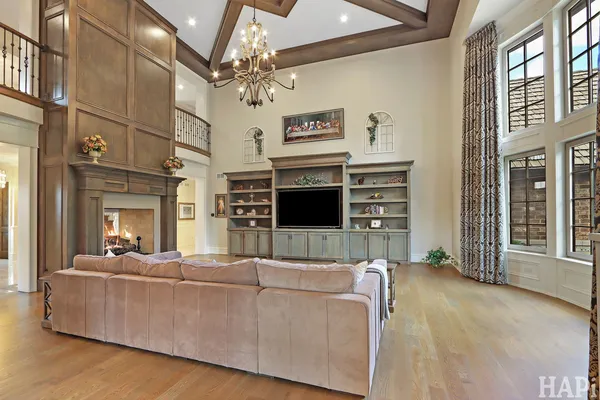 a large white kitchen with a large window and stainless steel appliances