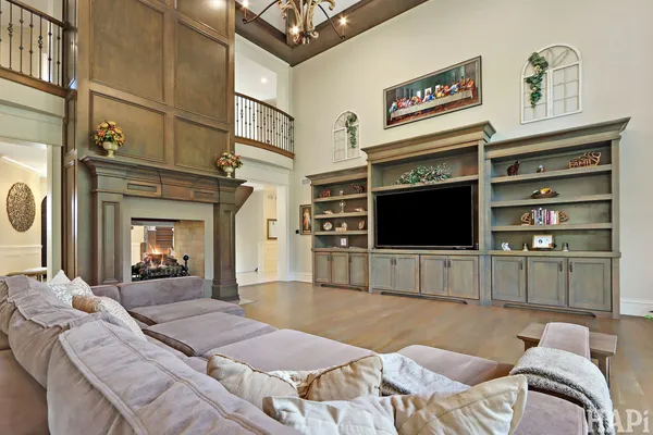 a large kitchen with kitchen island a large counter space stainless steel appliances and cabinets