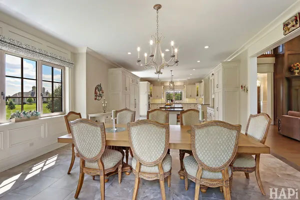 a kitchen with white cabinets and sink