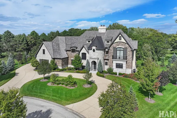 an aerial view of a house with yard and outdoor seating