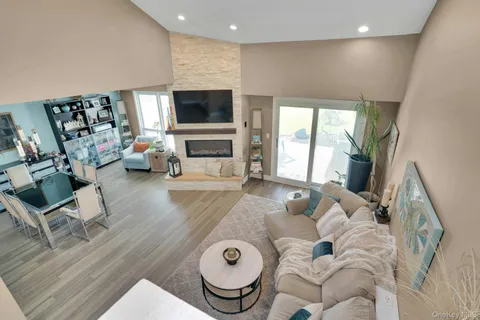 a living room with furniture fireplace and flat screen tv