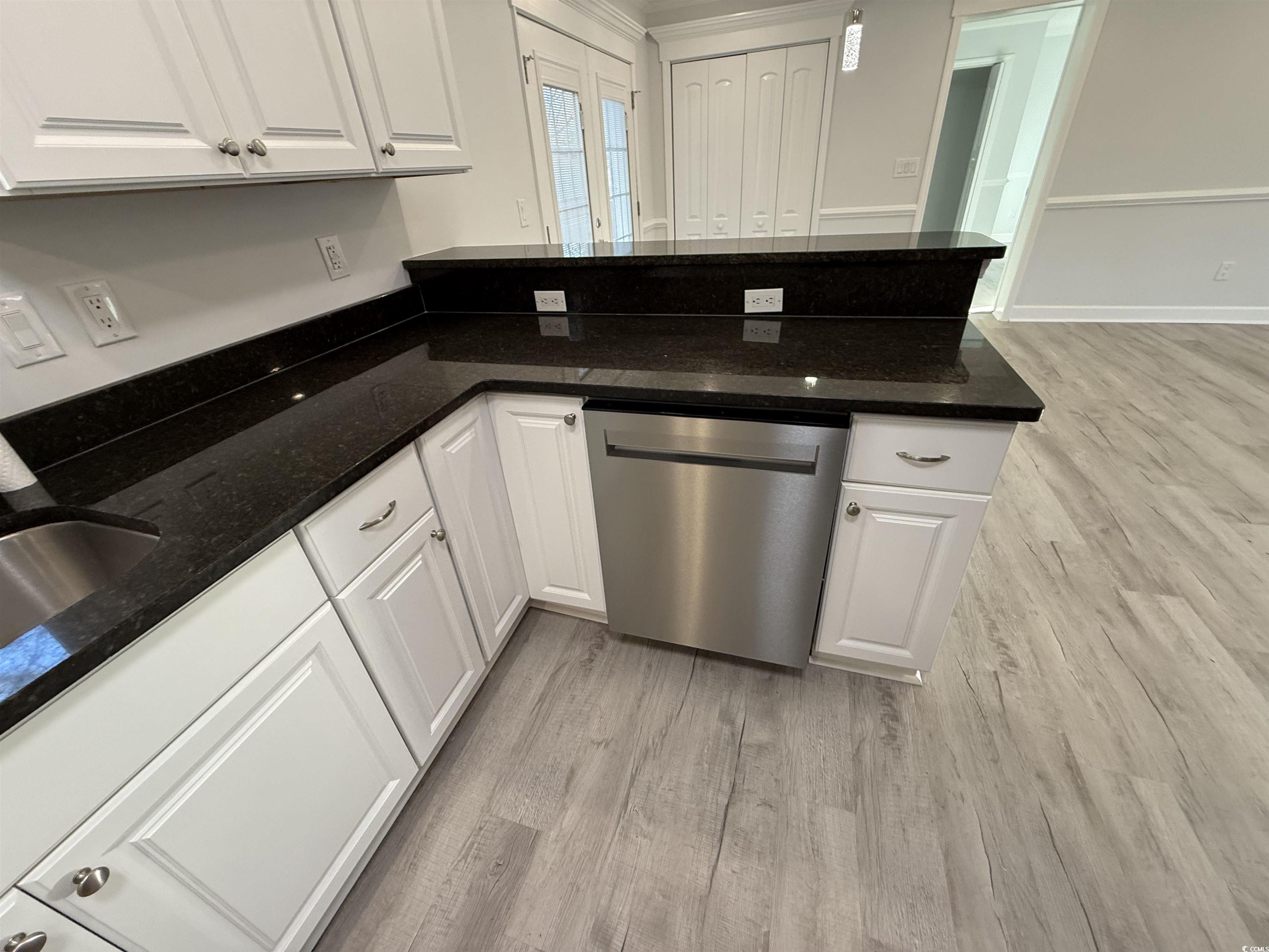 926 Forest Loop Road Conway, SC 29527 - Photo 5 of 14 Kitchen with light wood finished floors, dishwasher, dark stone countertops, a peninsula, and white cabinets