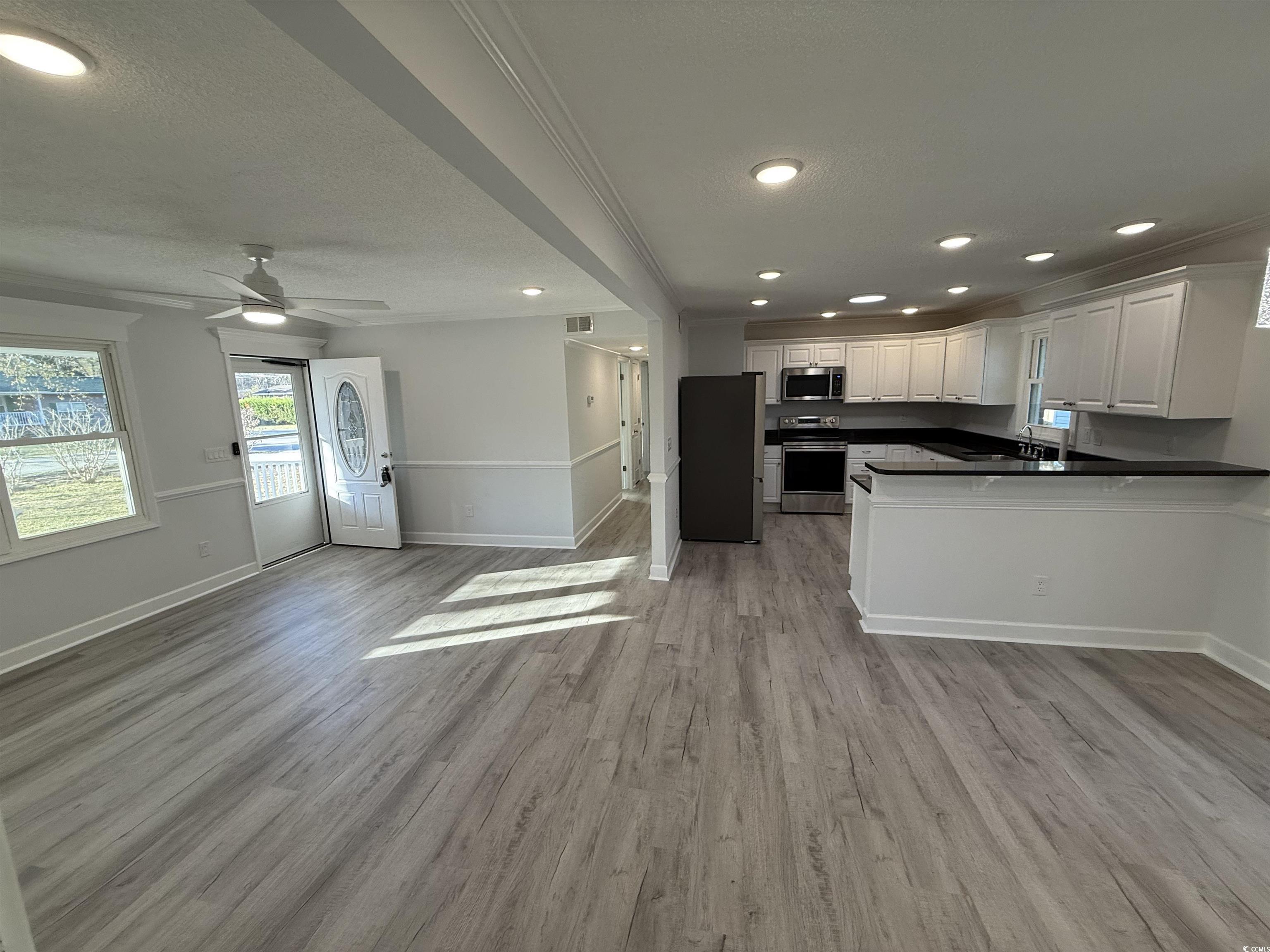 926 Forest Loop Road Conway, SC 29527 - Photo 14 of 14 Kitchen featuring a sink, light wood-style flooring, open floor plan, and stainless steel appliances