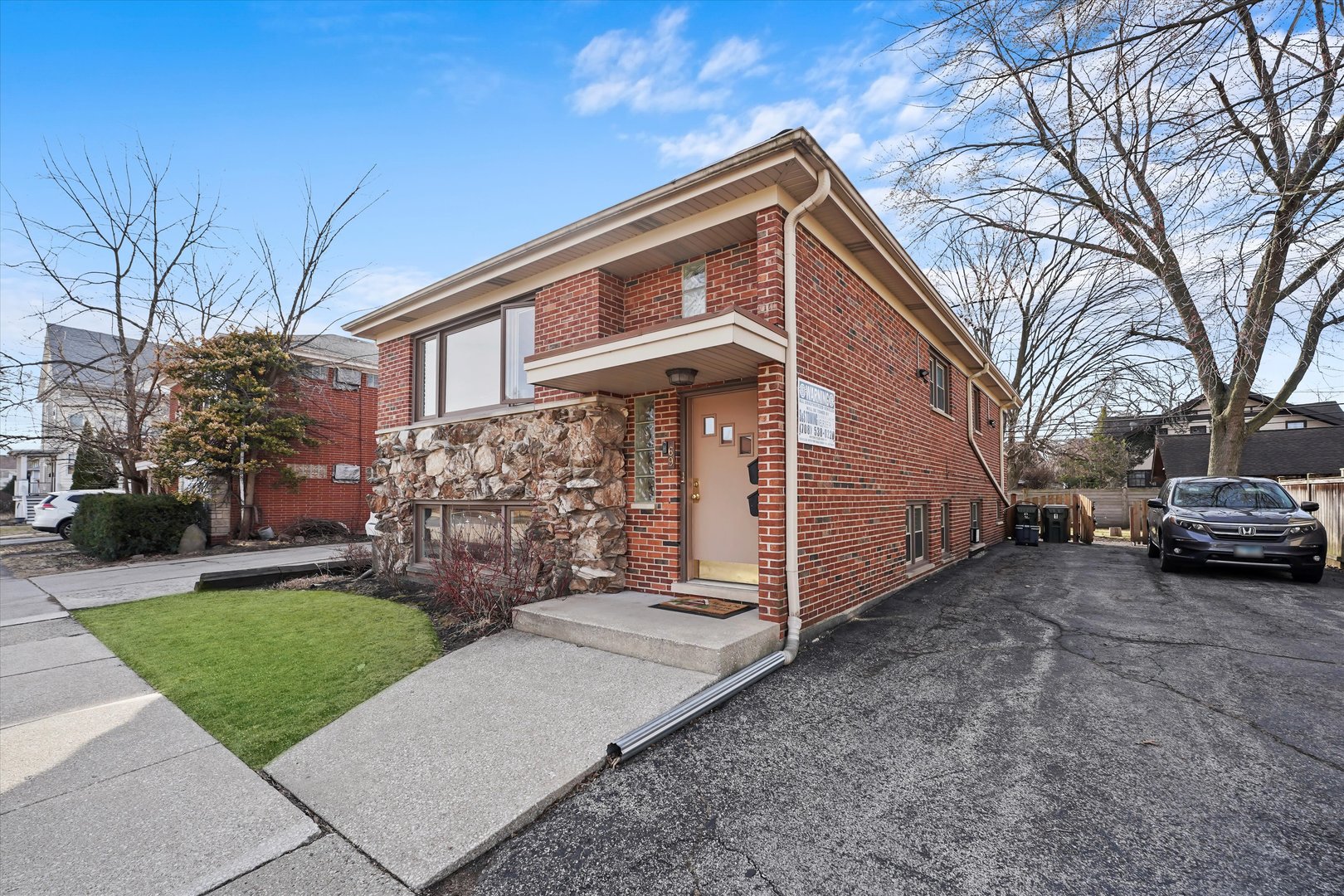 69 East Quincy Street, Unit 2 Riverside, IL 60546 - Photo 20 of 22 a front view of a house with a yard and garage