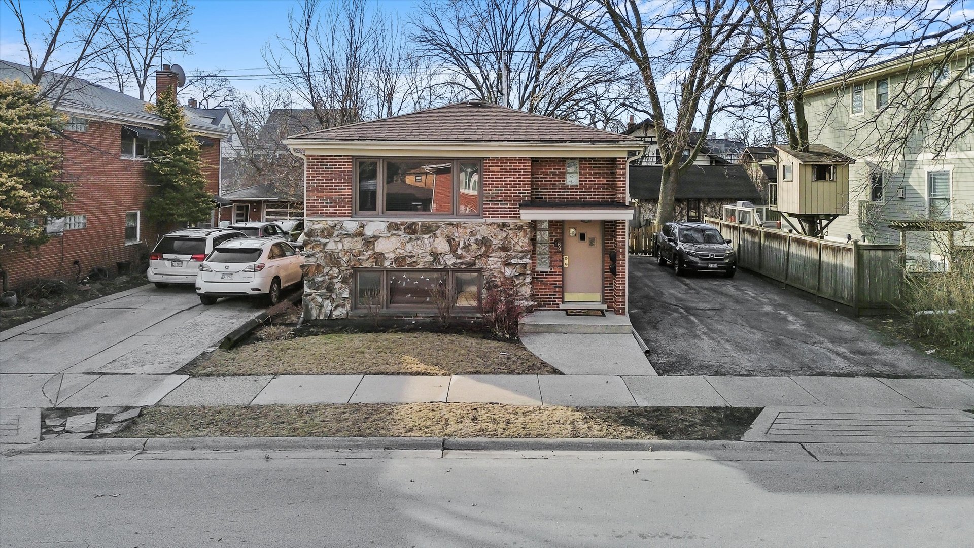 69 East Quincy Street, Unit 2 Riverside, IL 60546 - Photo 21 of 22 a front view of a house with parking space