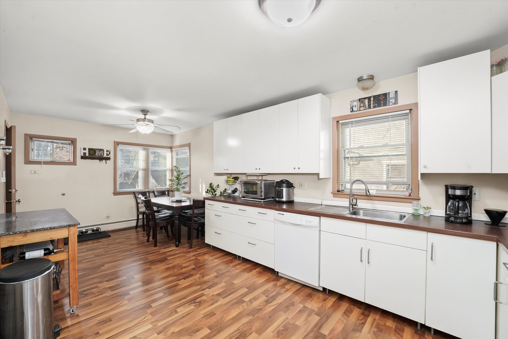 69 East Quincy Street, Unit 2 Riverside, IL 60546 - Photo 8 of 22 a kitchen with sink cabinets and wooden floor