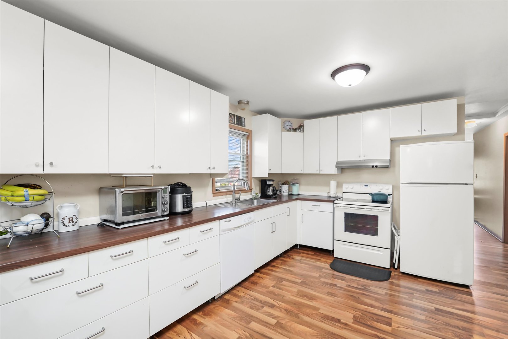 69 East Quincy Street, Unit 2 Riverside, IL 60546 - Photo 10 of 22 a kitchen with granite countertop white cabinets and white appliances